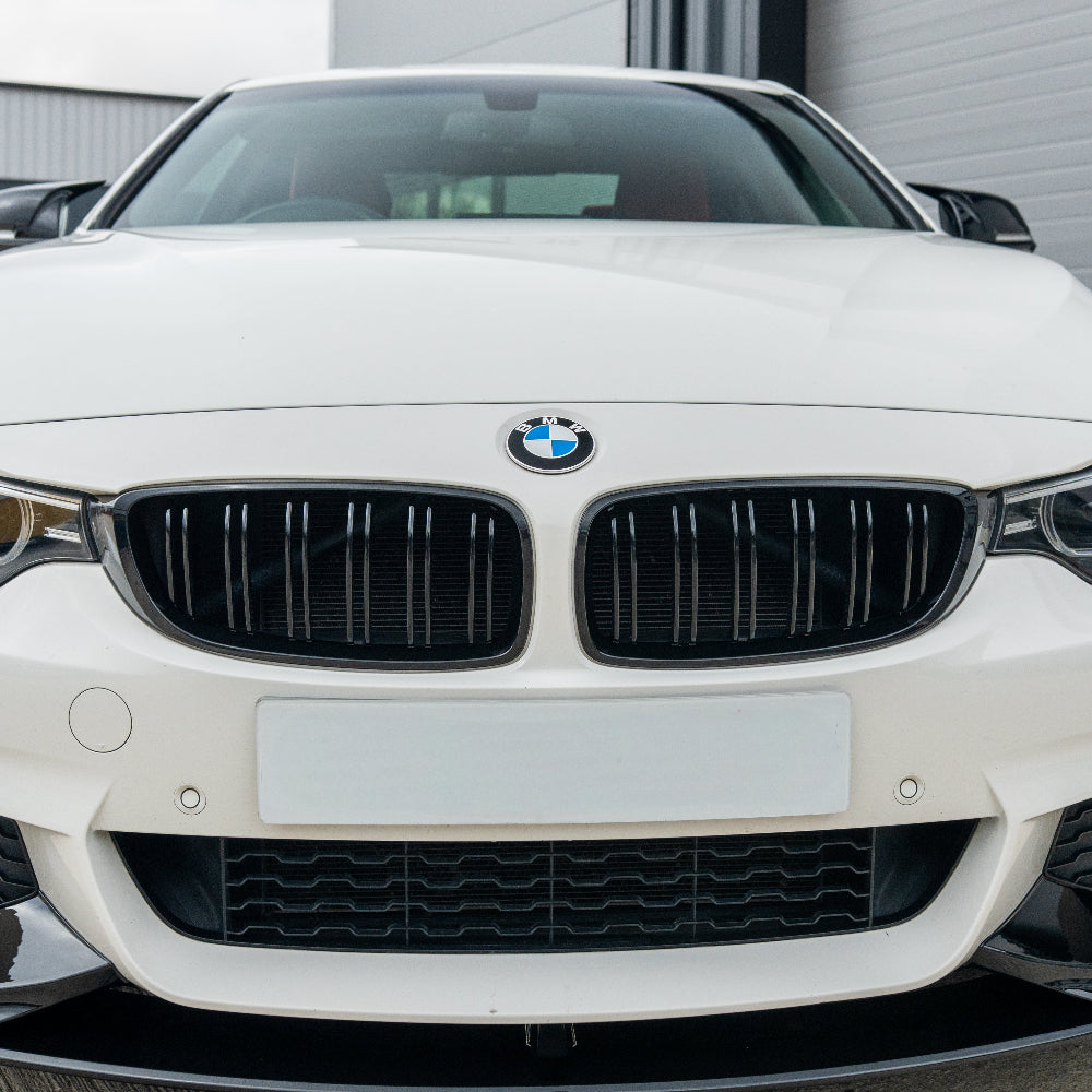 BMW M4 F82/F83 and 4 Series F32/F33/F36 double slat black grille by CT Carbon, showing close-up of sleek black grille design.