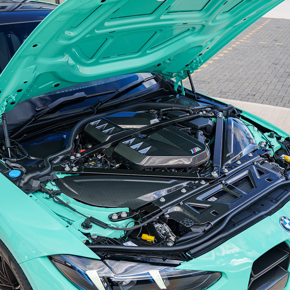 BMW M2 M3 M4 G87 G80 G81 G82 G83 Carbon Fibre Engine Bay Upper Trim accessory by CT Carbon, RHD, close-up view.