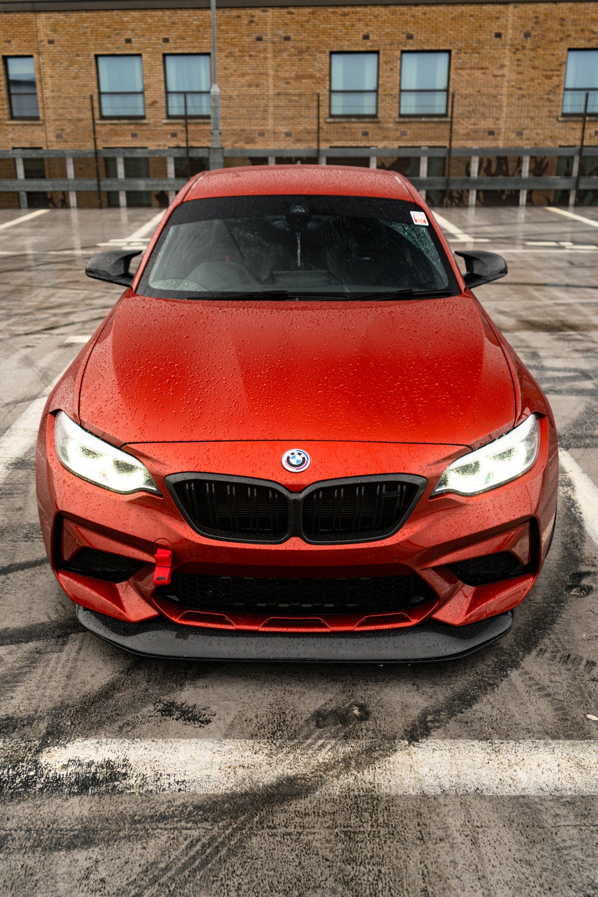 Ridgeline Motorsport F87 M2 Competition carbon fibre GTS front splitter installed on a BMW M2, showcasing its aerodynamic design.