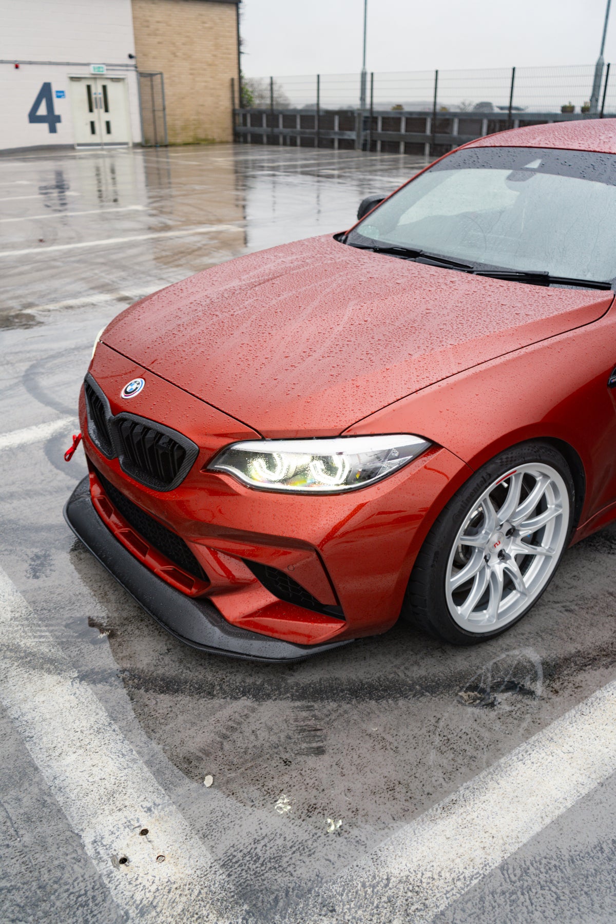 Ridgeline Motorsport F87 M2 Competition carbon fiber GTS front splitter installed on a BMW M2 Competition car.
