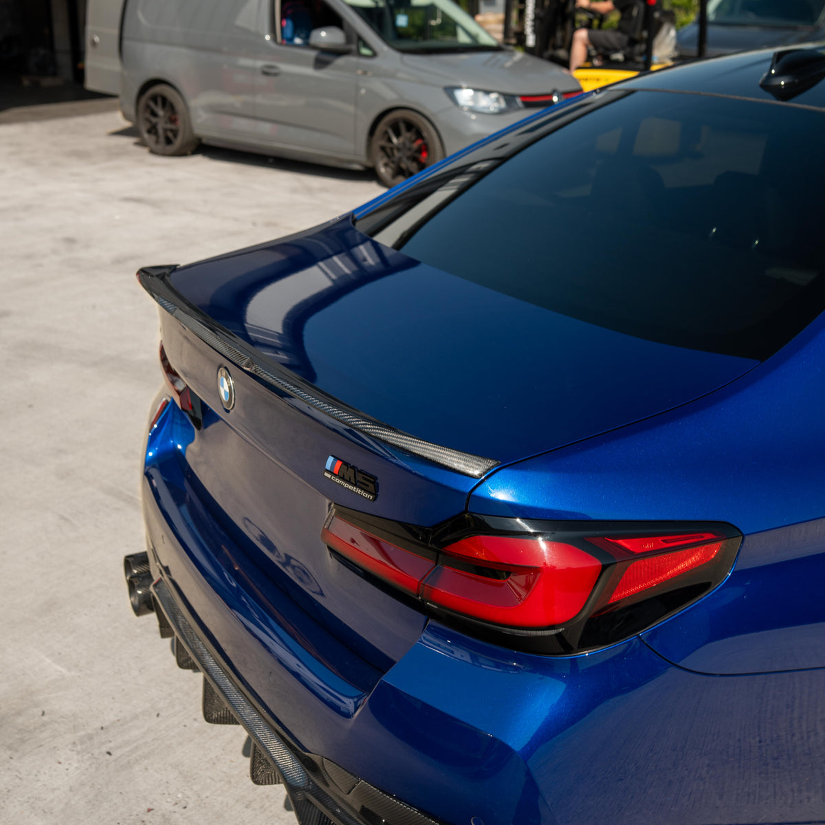 BMW M5 F90 and G30 5 Series carbon fiber spoiler by CT Carbon, shown on the car’s rear with sleek, aerodynamic design.