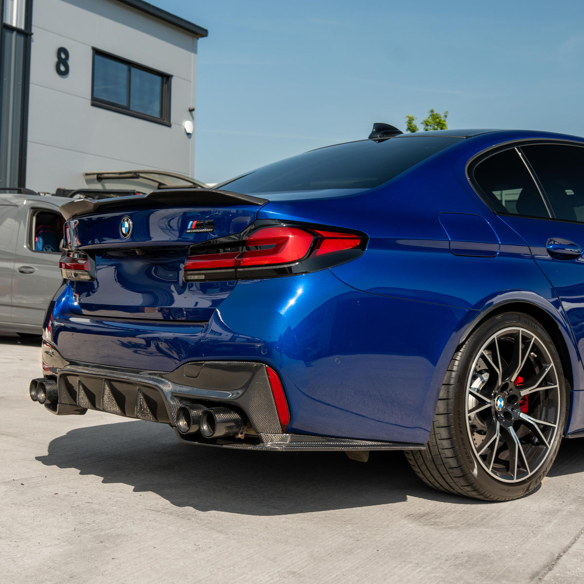 BMW M5 F90 and G30 5 Series carbon fibre spoiler by CT Carbon, shown on car with sleek aerodynamic design.