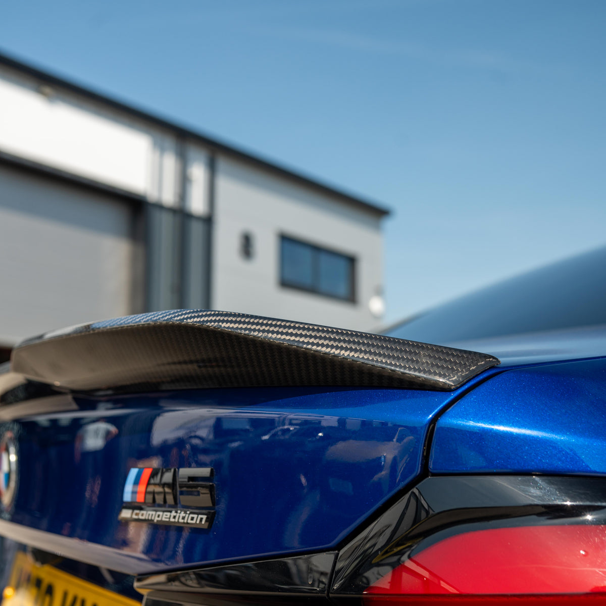 BMW M5 F90 and G30 5 Series carbon fibre spoiler by CT Carbon, shown installed on the vehicle with a sleek aerodynamic design.