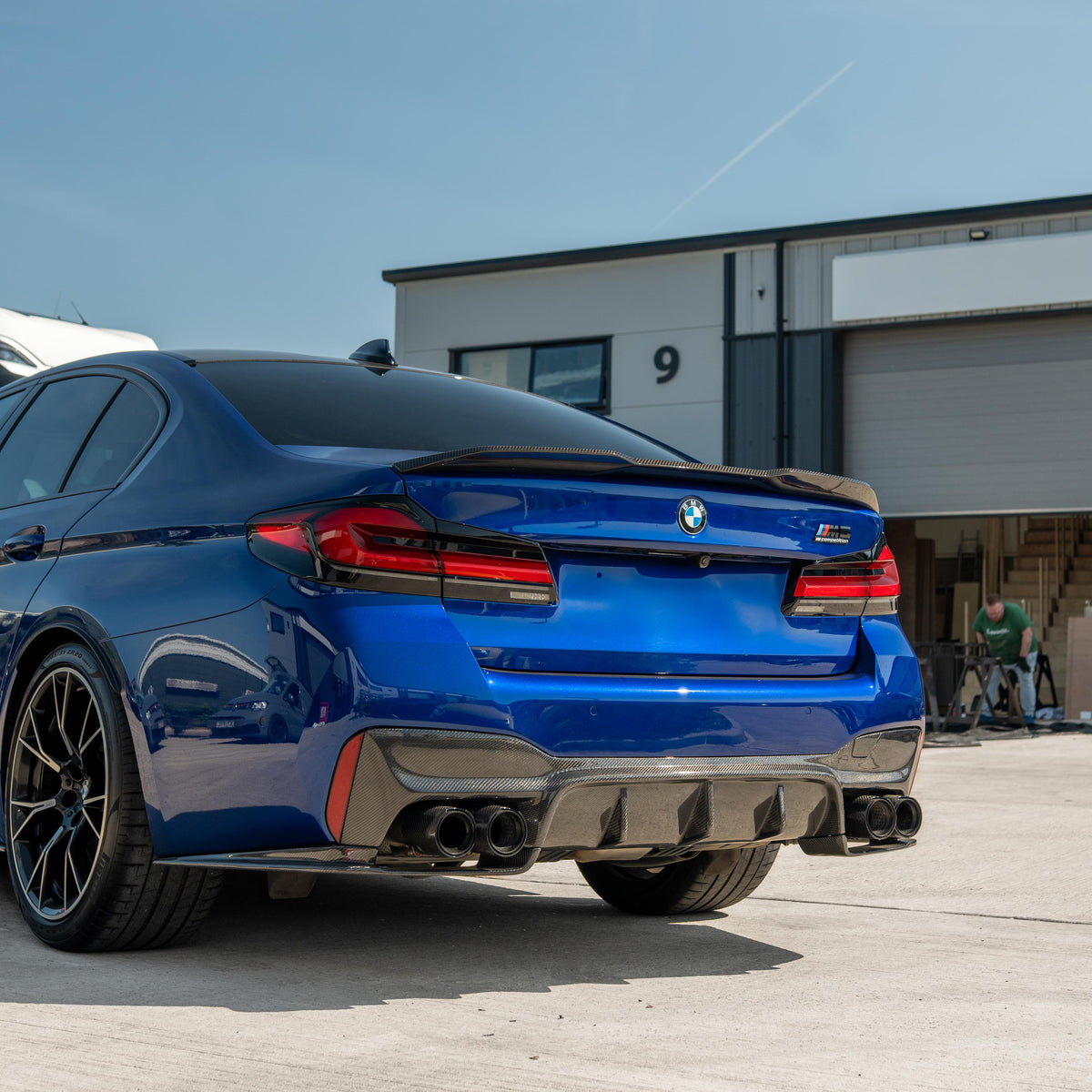 BMW M5 F90 and G30 5 Series carbon fibre spoiler by CT Carbon, shown on a sleek sports car with a matte finish.