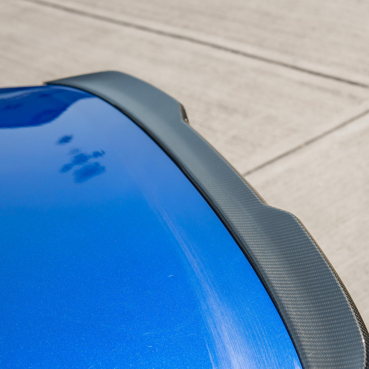 BMW M5 F90 and G30 5 Series carbon fibre spoiler by CT Carbon, shown on a sleek sports car with a detailed view of the spoiler.