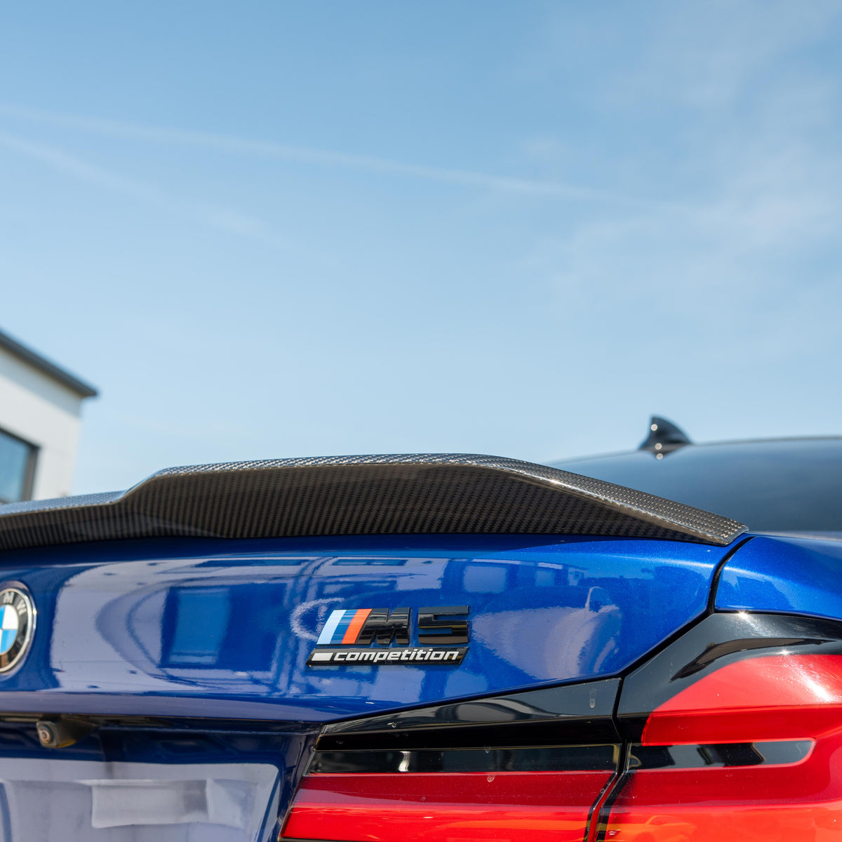 BMW M5 F90 and G30 5 Series carbon fibre spoiler by CT Carbon, showing the sleek, aerodynamic design on a silver car.
