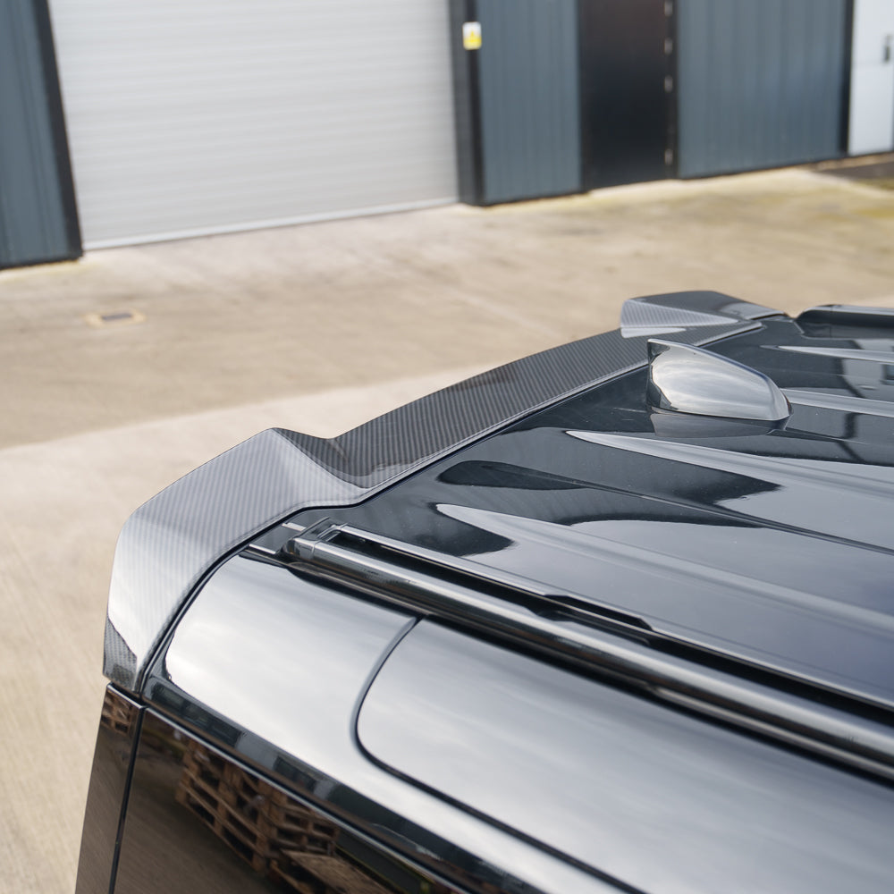 Carbon fiber spoiler for Land Rover Defender L663 by CT Carbon, shown on the vehicle's rear profile.