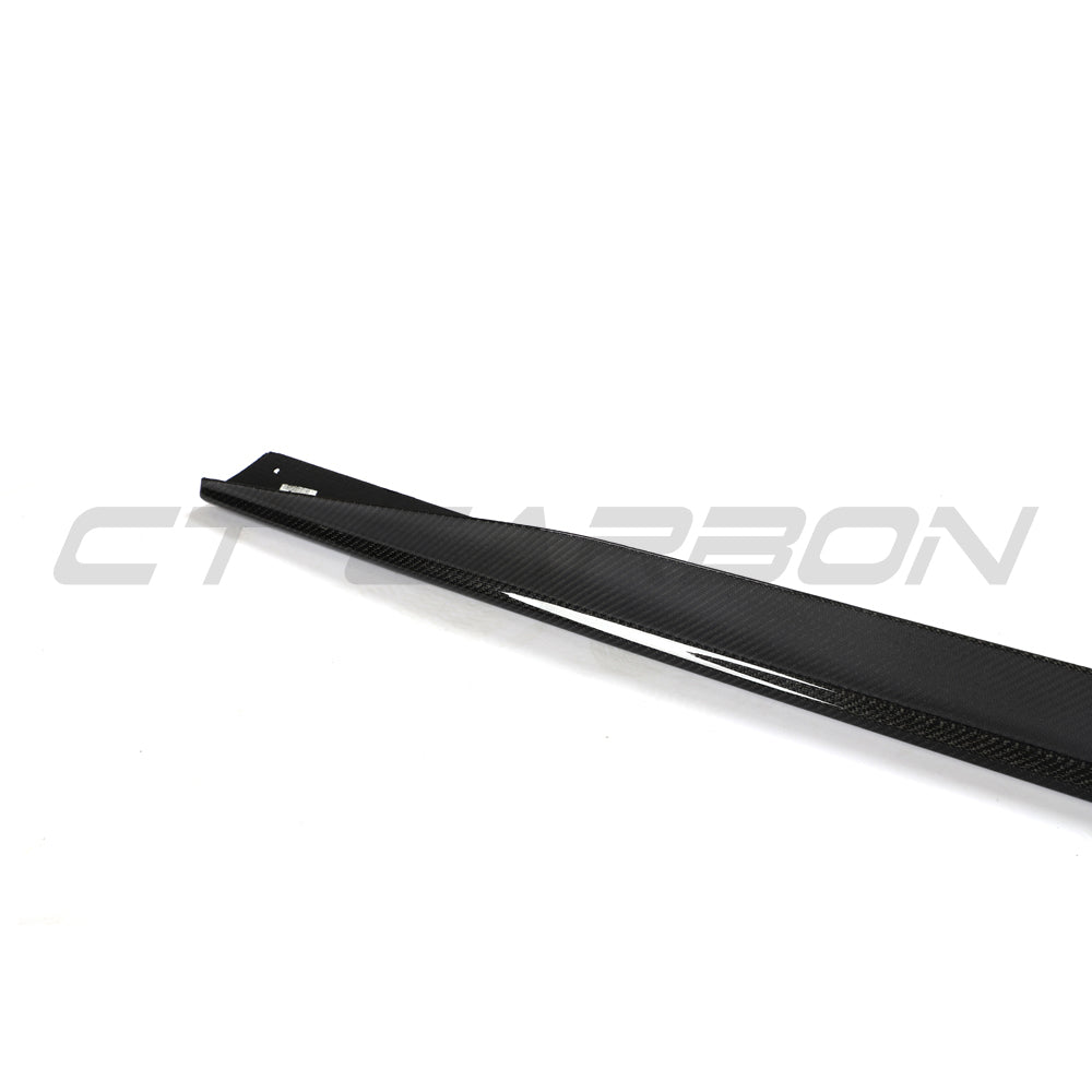 BMW 4 Series G26 and i4 carbon fibre side skirts by CT Carbon, showing sleek, textured exterior enhancements for sporty appearance.