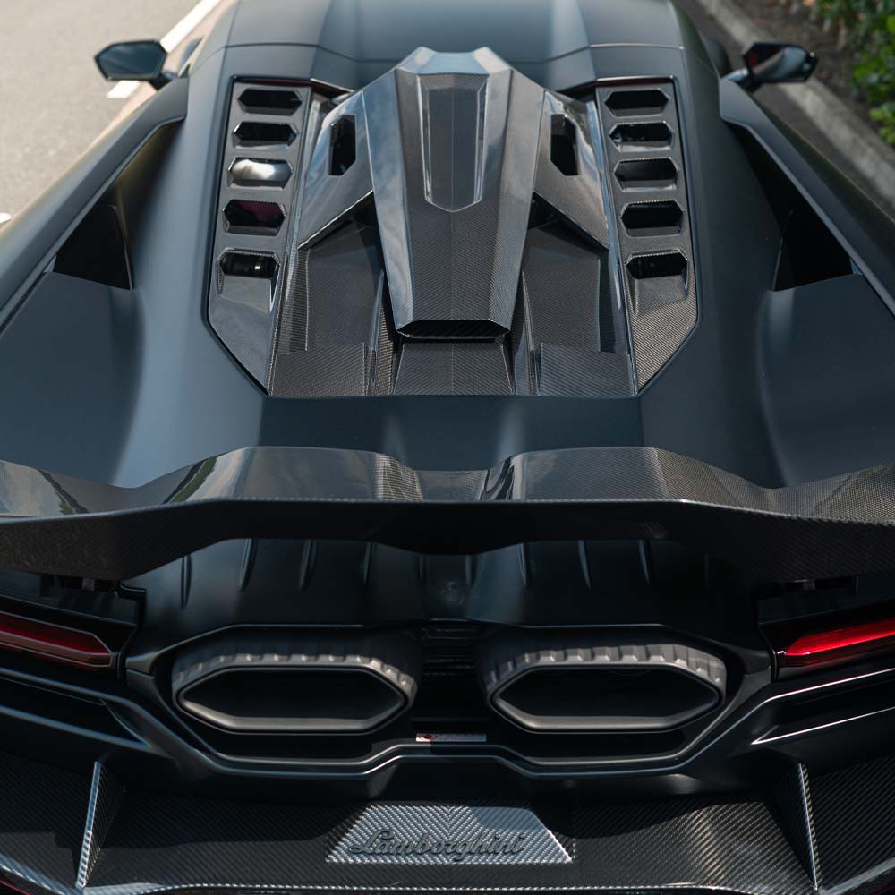 Lamborghini Revueltto carbon fibre engine cover and roof scoop by CT Carbon, showcasing sleek aerodynamic design and high-quality material