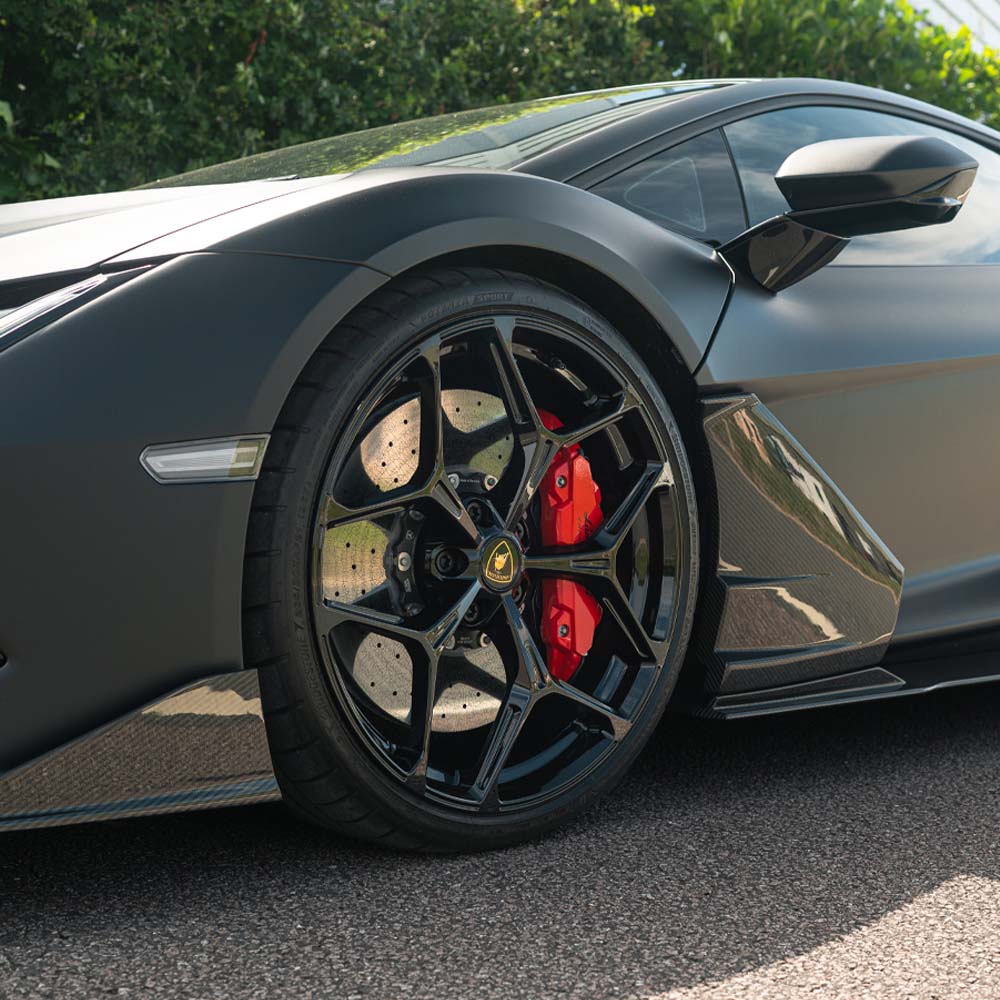 Lamborghini Revuelto carbon fibre side skirts by CT Carbon, featuring sleek design and textured finish on the car doors.