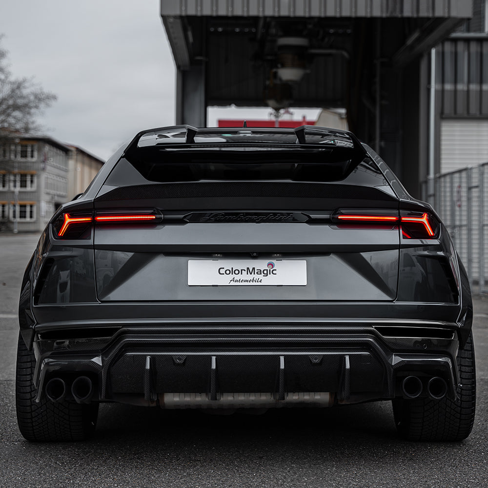 Lamborghini Urus carbon fibre diffuser by CT Carbon, showcasing sleek, textured carbon fibre details and aerodynamic design.