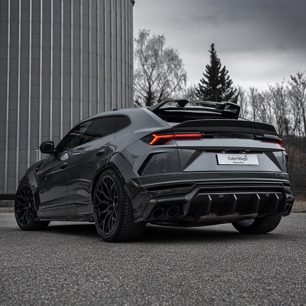 Lamborghini Urus carbon fiber diffuser by CT Carbon, showcasing sleek black carbon fiber with detailed aerodynamic design.