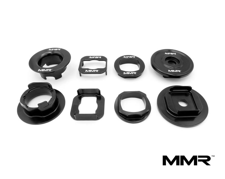 BMW F2x F3x suspension linkage with MMX Performance billet subframe inserts, showing precise machined metal components.
