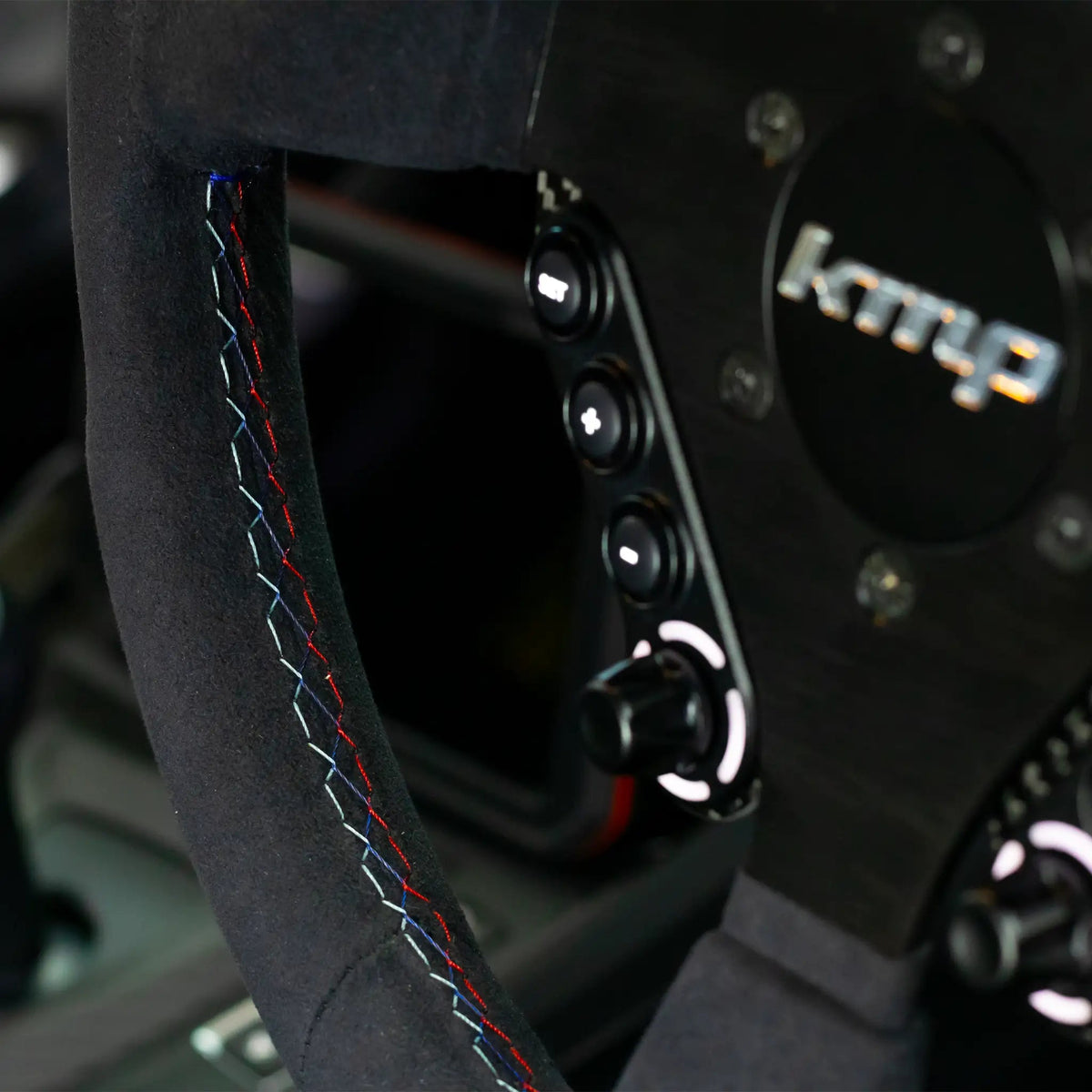 KMP Clubsport BMW FXX steering wheel with custom stitching, black leather grip, and silver accents for sporty driving.