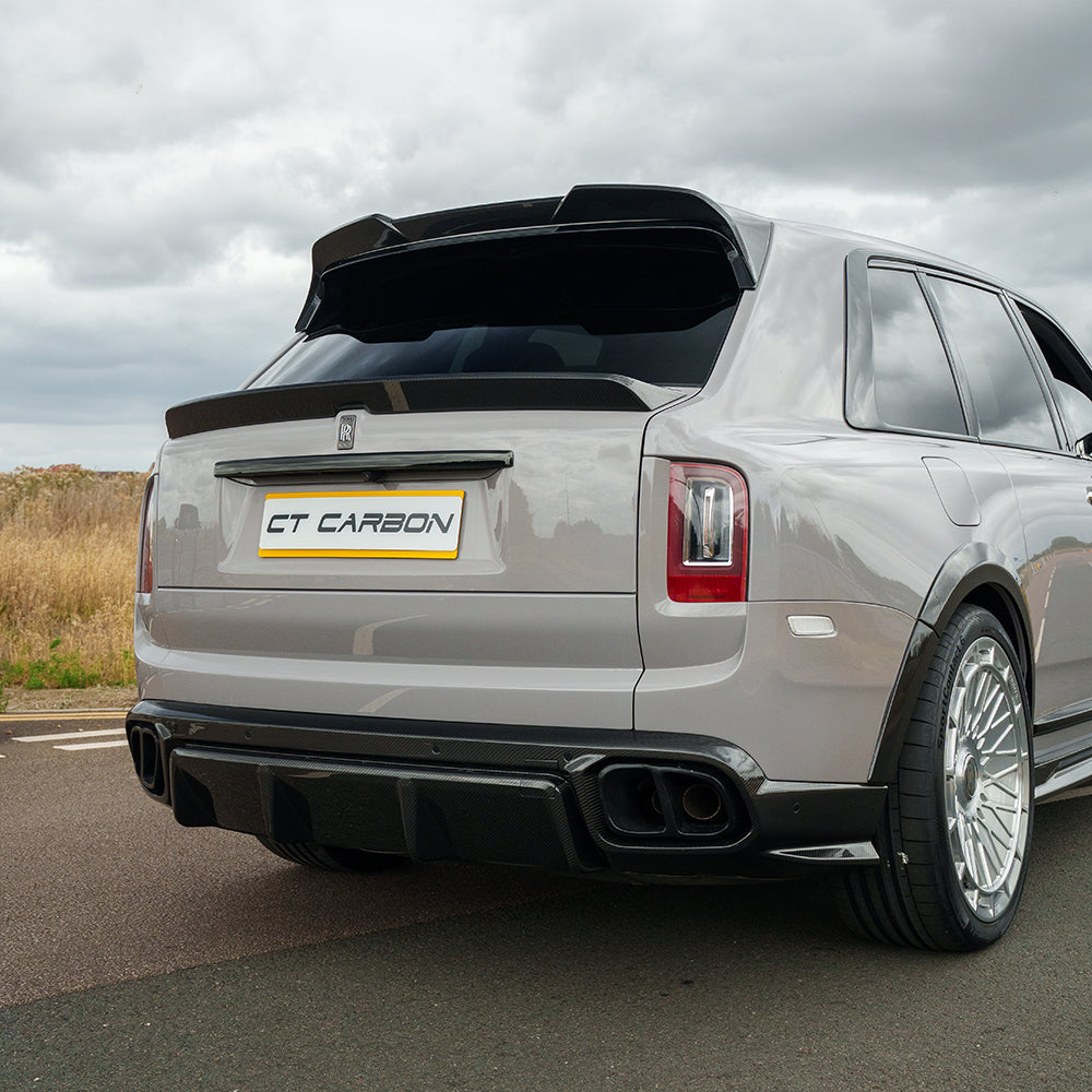 Rolls Royce Cullinan carbon fibre splitter and diffuser tips by CT Carbon, showcasing sleek design on the vehicle's rear.