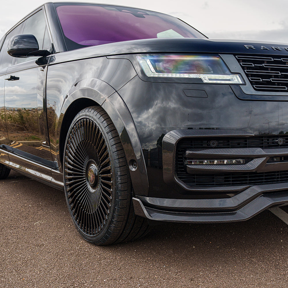 Range Rover L460 2022+ carbon fiber wide arch extensions by CT Carbon, showing sleek, textured carbon fiber arches on the vehicle.