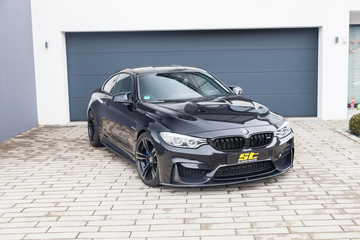 ST Suspension coilovers for BMW F80 M3, F82 M4, F83 M4 with adjustable damping and top mounts, installed on coupe model.