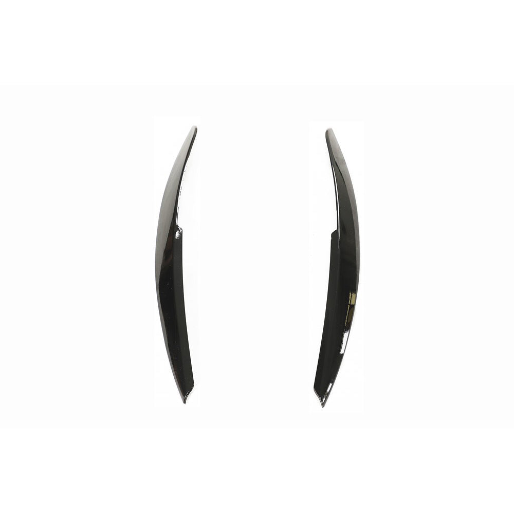 Volkswagen Polo MK5 gloss black headlight eyebrows accessory by CT Carbon, showing sleek black accents on the vehicle's headlights.