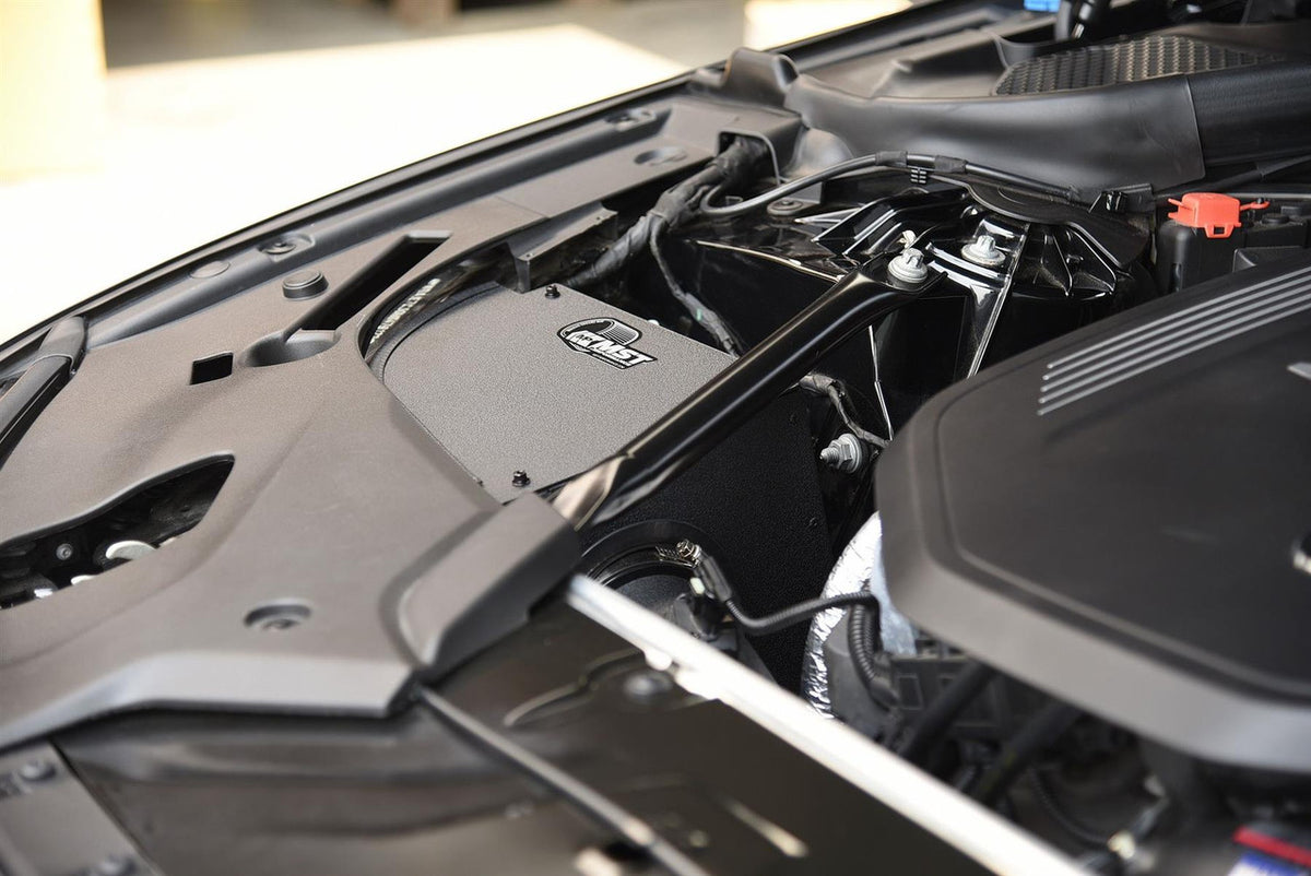 MST Performance induction kit installed in a BMW B58 540i engine bay, showcasing the high-performance air intake components.