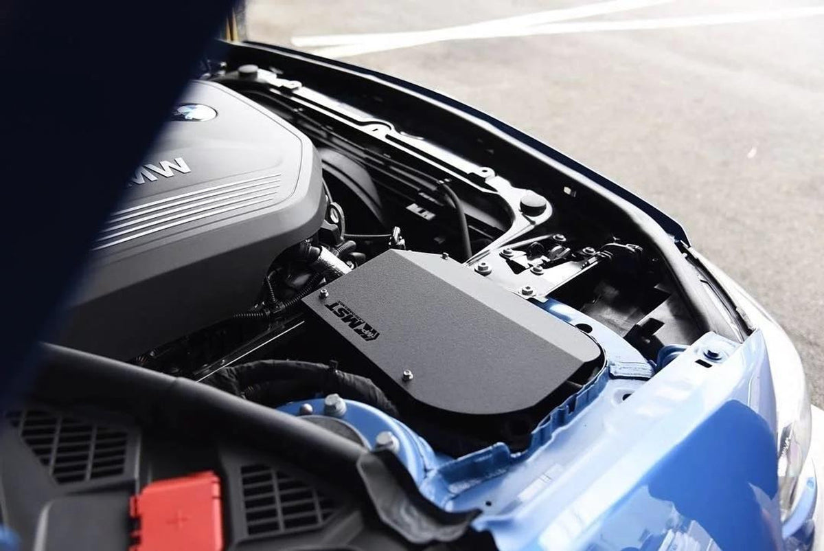 MST Performance induction kit for BMW 3.0 B58 engine, showing the air intake components and tubing in a close-up shot.
