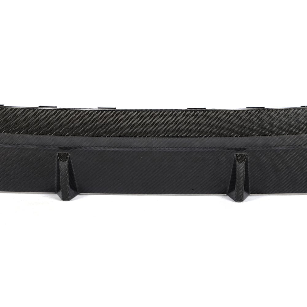 Black BMW G22 4 Series carbon fiber diffuser kit by CT Carbon, featuring sleek carbon fiber accents for sporty style.