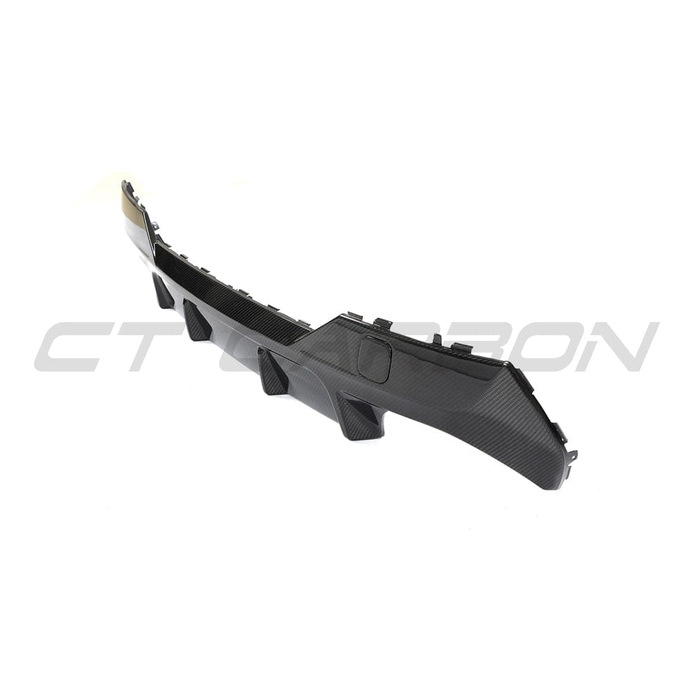 Black BMW G22 4 Series carbon fibre diffuser kit by CT Carbon, showcasing sleek, lightweight carbon fiber design for enhanced performance.