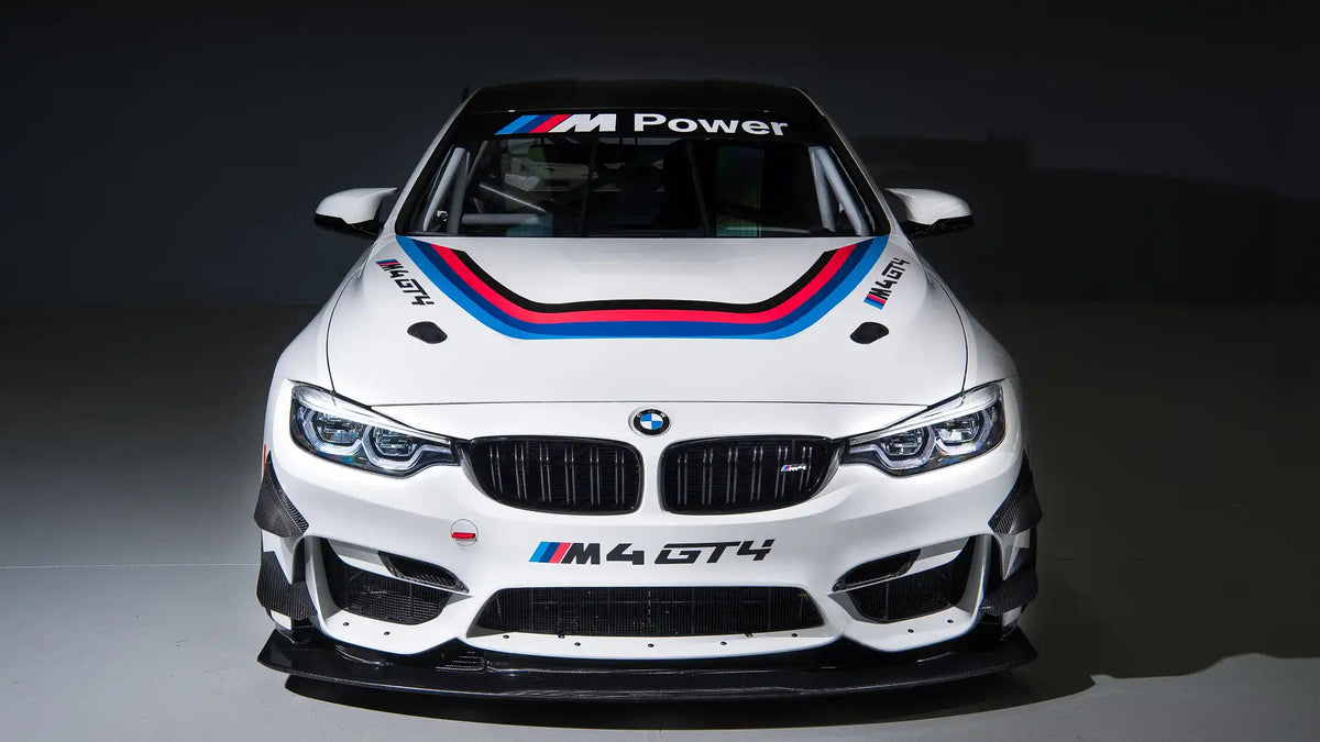 Genuine BMW Motorsport M4 GT4 racing radiator protective grille and mounting frame for exterior trim, black metal with mounting hardware.
