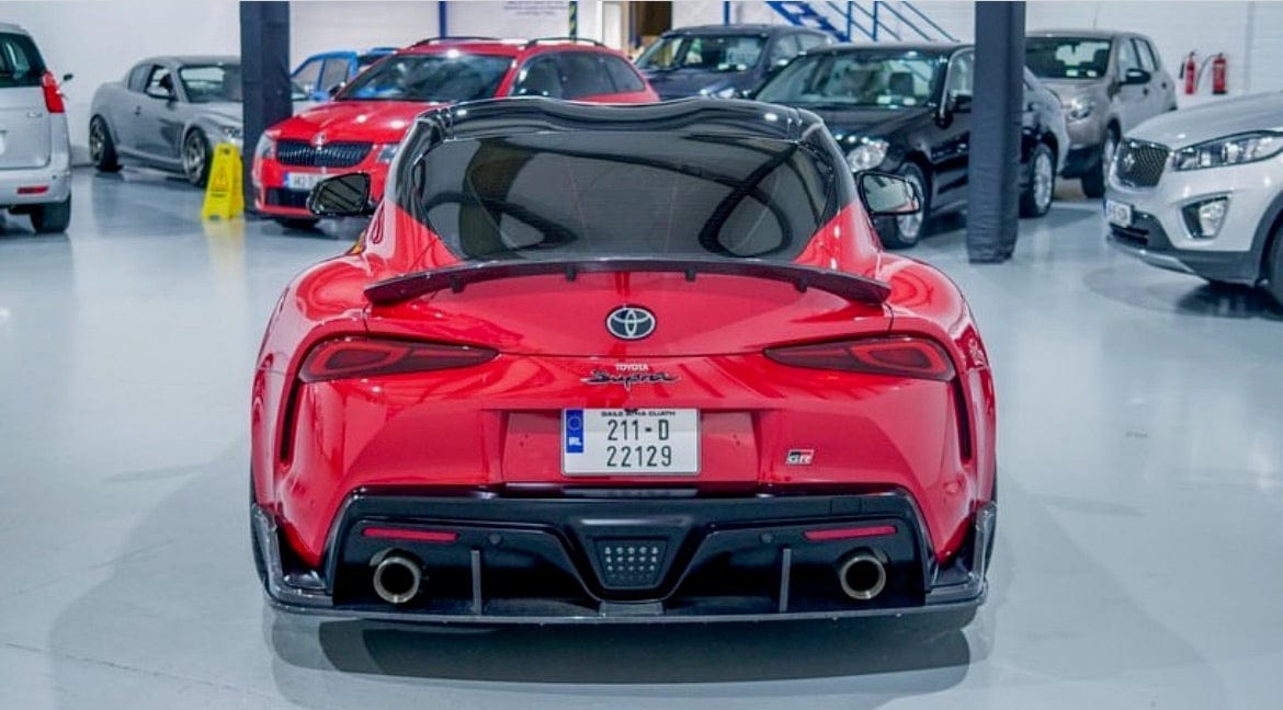 Toyota Supra 2019+ A90 CT Carbon carbon fiber diffuser, showing the sleek aerodynamic design and textured finish.