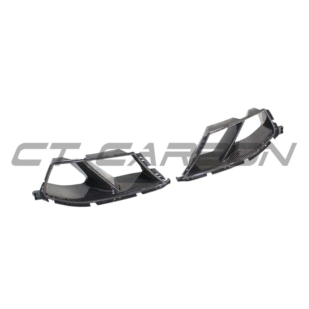 BMW M3 M4 G80 G82 G83 carbon fibre bumper ducts by CT Carbon, showing sleek, lightweight aerodynamic accessories on a sports car.
