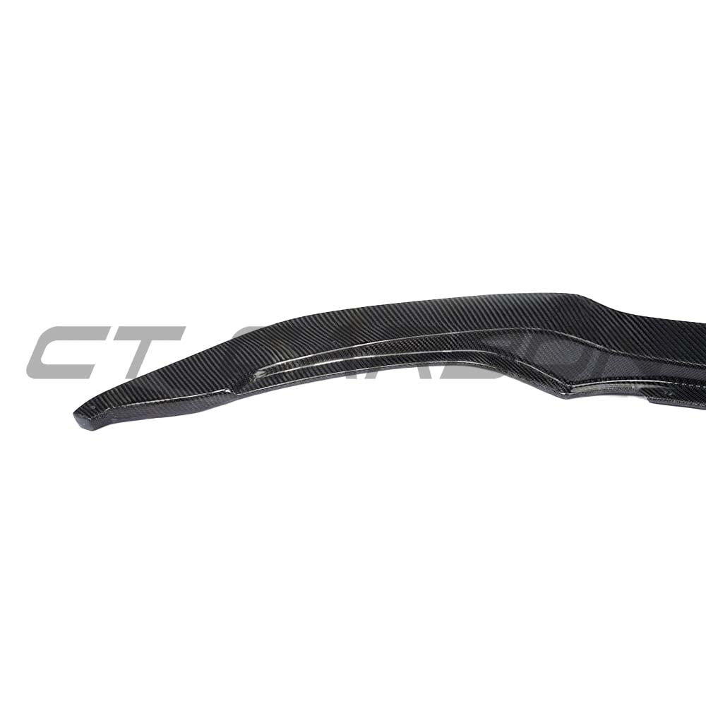 BMW M3 M4 F80 F82 F83 carbon fibre V4 splitter by CT Carbon installed on front of vehicle, showcasing sleek aerodynamic design.