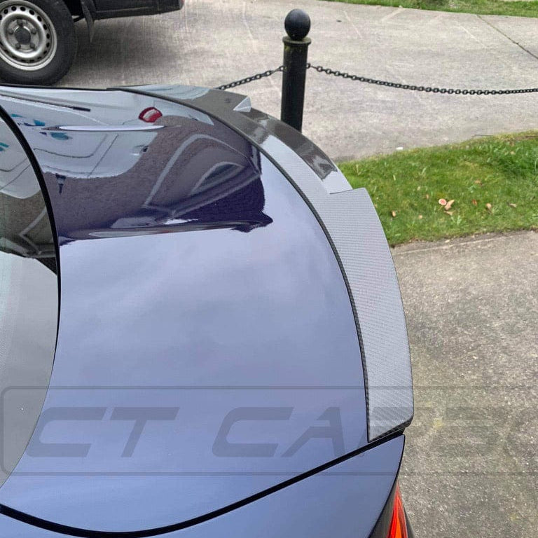 BMW M4 F82 carbon fibre spoiler by CT Carbon, MP Style, shown on the car's rear with sleek, aerodynamic design.