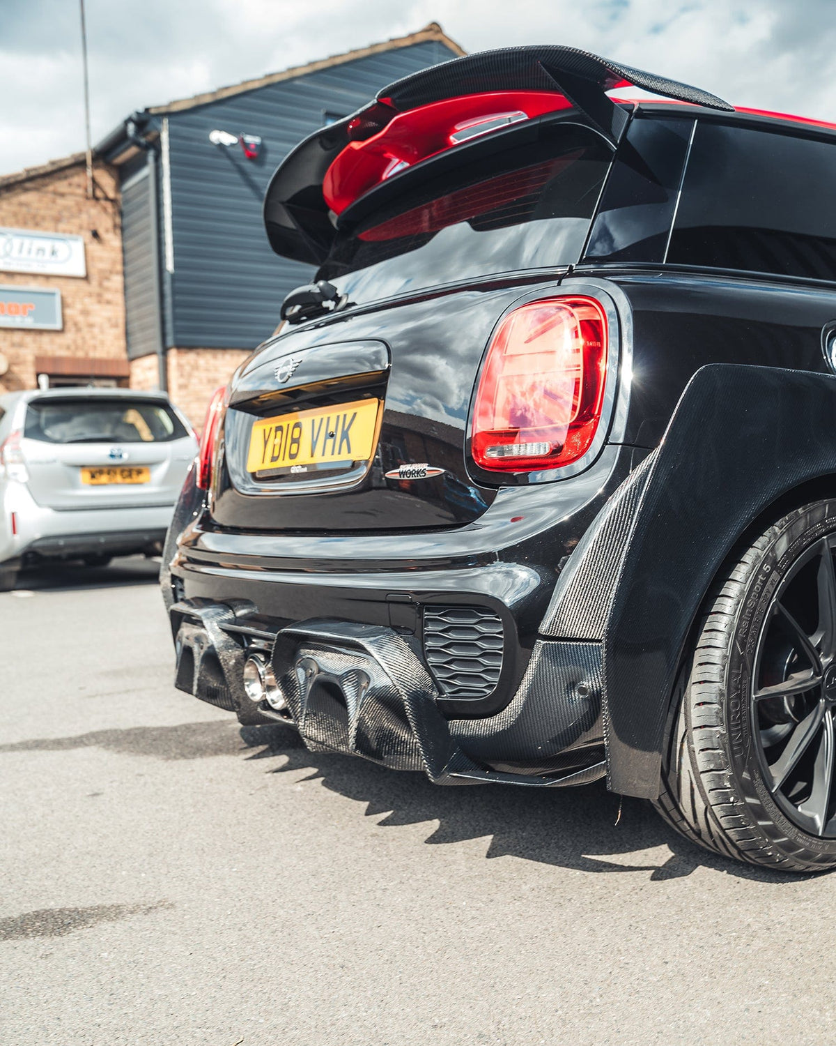 Carbon fiber spoiler for Mini Cooper S F56/JCW Sport Pack by CT Carbon, showcasing sleek, aerodynamic design on the vehicle.