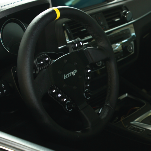 KMP Drivetrain Clubsport BMW FXX steering wheel with illuminated interior lighting and sporty design.