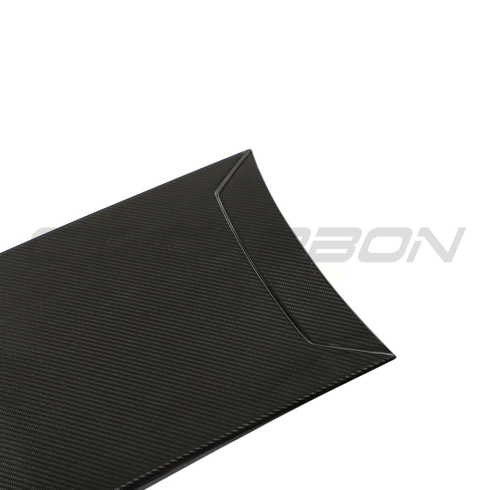 Carbon fibre roof scoop accessory for McLaren 570S and 570GT by CT Carbon, shown on the car's roof in an outdoor setting.