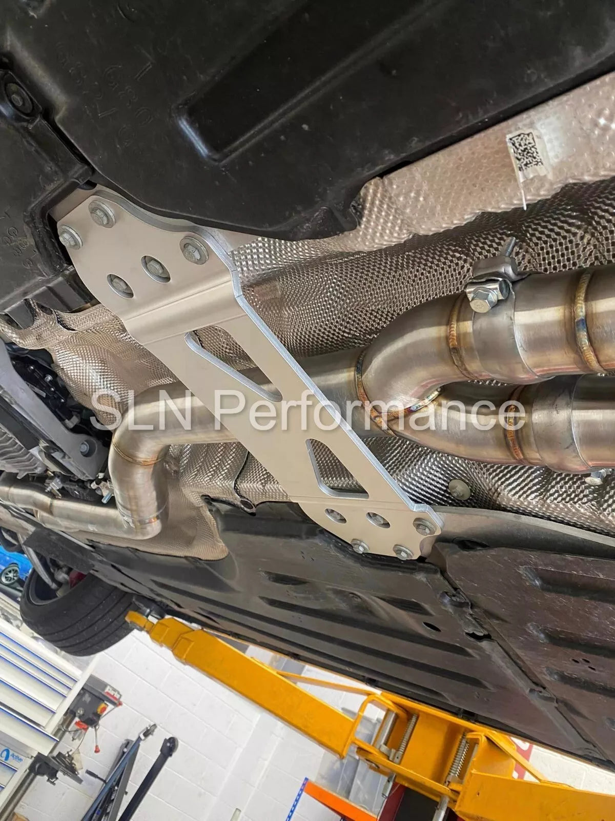 SLN Performance BMW S58 M3 G80 M4 G82 X3M X4M LCI single mid pipe centre section with under-brace, high-performance exhaust component.